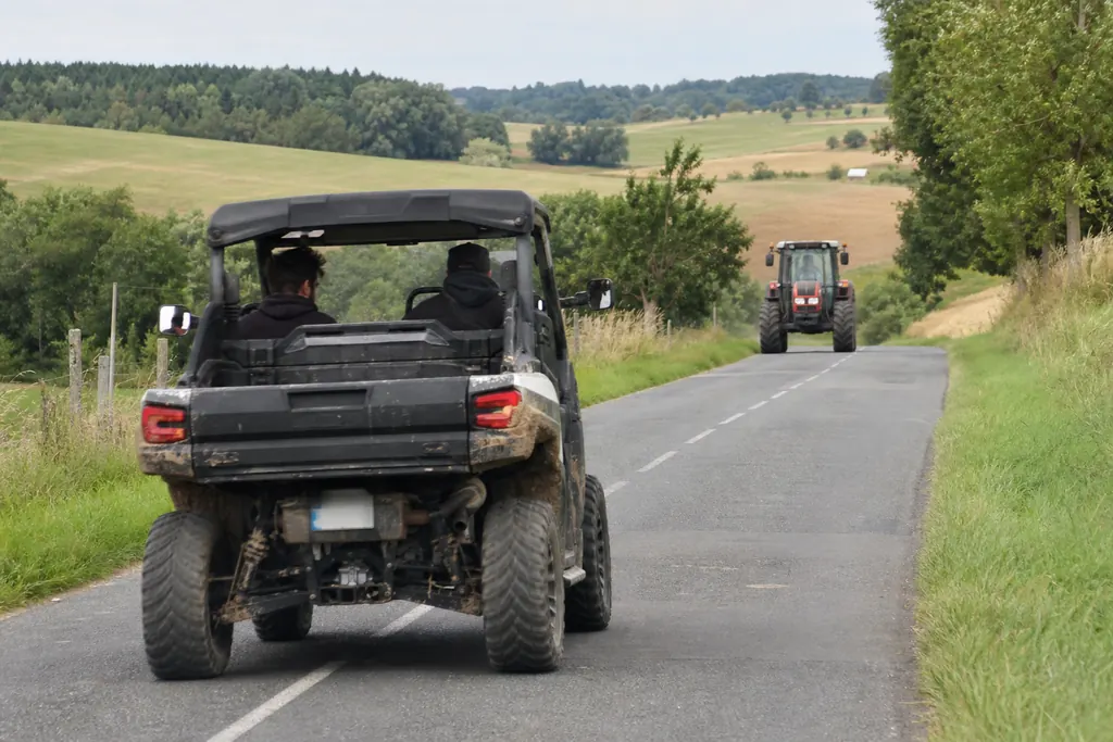 Un SSV homologué circule sur une route départementale à travers les champs